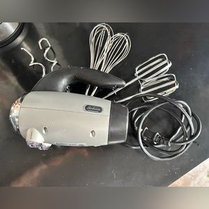 Sunbeam hand mixer with stainless steel bowl with lid for storage mixing.
